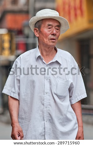 BEIJING, CHINA -JUNE 9, 2015. Chinese senior in city center. Elderly population (60 or older) in China is 128 million, one in every ten people, the world\'s largest. China will have 400 million elderly by 2050