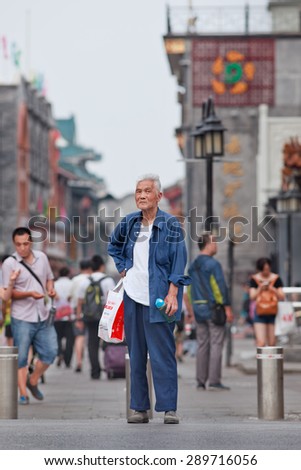 BEIJING, CHINA -JUNE 9, 2015. Handsome old man in city center. Elderly population (60 or older) in China is 128 million, one in every ten people, the world's largest. China has 400 million elderly by 2050.