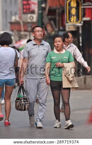 BEIJING, CHINA -JUNE 9, 2015. Middle-aged couple in city center. Recent study showed divorce rate among middle-aged Chinese couples has risen last two decades, while divorce rate among 20s couples has dropped
