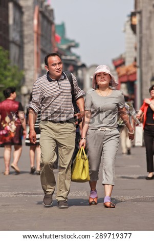BEIJING, CHINA -JUNE 9, 2015. Middle-aged couple in city center. Recent study showed divorce rate among middle-aged Chinese couples has risen last two decades, while divorce rate among 20s couples has dropped