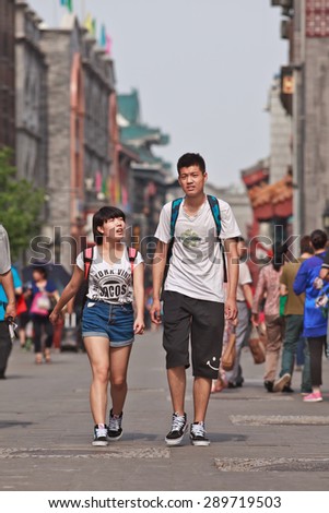 BEIJING, CHINA -JUNE 9, 2015. Youngsters in shopping street. According 2010 national census, China\'s unmarried population is huge: about 249 million 18-and-older Chinese are not married (18.6% of population).