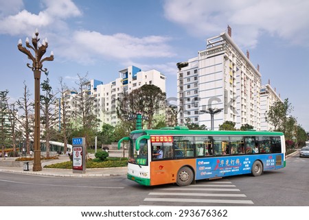 KUNMING-JULY 7, 2014. Bus with advertisement. China\'s outdoor advertising market has grown annually more than 23% since 2000, versus 17% for the overall ad market, 14% for TV and 16% for newspapers.