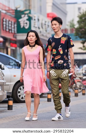 BEIJING-JULY 10, 2015. Young lovers on the street. According 2010 national census, China\'s unmarried population is huge: about 249 million 18-and-older Chinese are not married (18.6% of population).