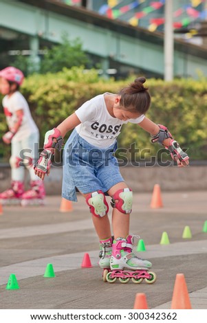 BEIJING-JULY 24, 2015. Girl practicing inline skating. Although Ping-Pong, basketball and badminton are China\'s top sports, last decade inline skating became increasingly popular among its youth.
