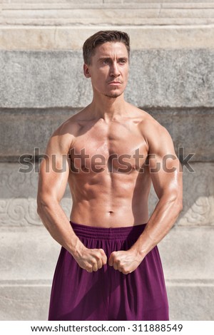 Bare chested muscled martial arts master practicing at Temple of Heaven, Beijing, China