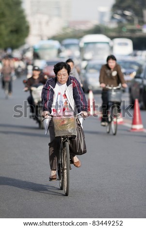 BEIJING - SEPT. 26. Elderly cycles in downtown Beijing. From 1995 to 2005, China\'s bike fleet declined by 35 percent and private car ownership more than doubled. Beijing on September 26, 2008.