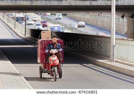 BEIJING - OCT. 25: Cargo bike on the road in Beijing, Oct. 25, 2011. Although their number is declining, cargo bikes or freight tricycles are still a popular transportation mode in China.