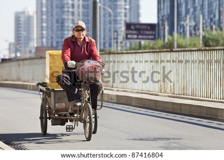 BEIJING - OCT. 25: Cargo bike on the road in Beijing, Oct. 25, 2011. Although their number is declining, cargo bikes or freight tricycles are still a popular transportation mode in China.