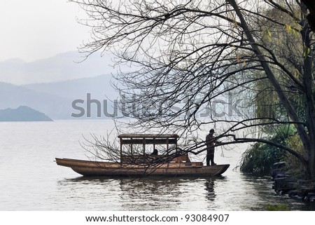 HANGZHOU - DEC. 23, 2009. Boat moors at the bank of West Lake on Dec. 23, 2009. It is a famous lake in the historic area of Hangzhou, China, and It was made a UNESCO World Heritage Site in 2011.
