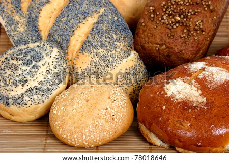 Bread Different types of bread: long loaf with poppy, buns with poppy and with onion, bun with powdered sugar, rye-bread