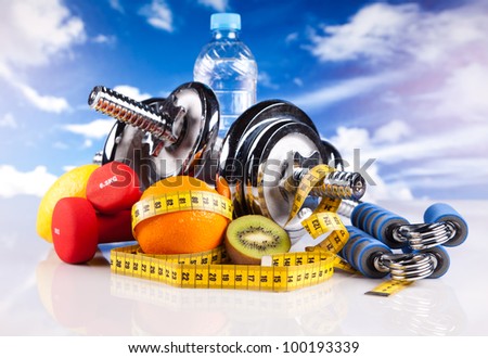 steel fitness dumbbells, bottle of water, hand grip, fruits and colorful strings