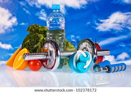 fitness dumbbells, water, hand grip and fruits