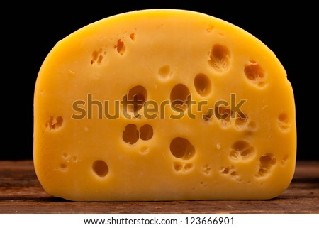 block of cheese isolated on black