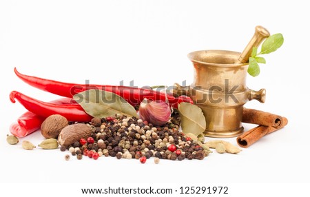 brass mortar with spices isolated on white