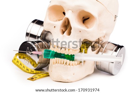 fitness equipment and human skull isolated on white