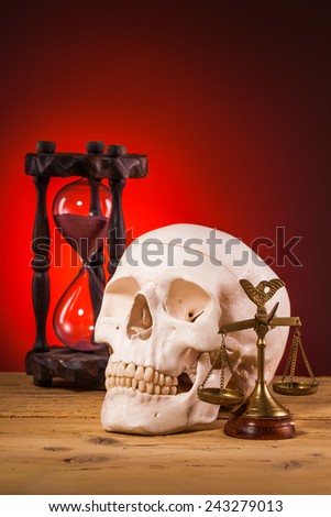 human scull and  scales of justice