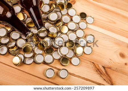 bottles  of homemade beer  and bottle caps on table