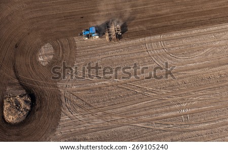 aerial view of harvest fields with tractor in Poland