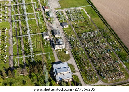 Aerial image of electrical substation featuring wires, transformers and large scale power energy towers in Poland
