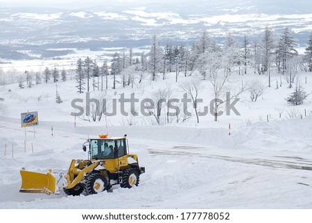 HOKKAIDO, JAPAN-JAN. 31, 2013: A tractor is cleaning snow at the top of snow mountain at Hakodate, Japan. Hokkaido in the most northern main island in Japan.