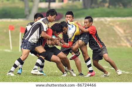 MALAYSIA - OCTOBER 15: Unidentified participants in action during a 10 Side Rugby Tournament Vice-Chancellor Cup at National Defense University Of Malaysia, Kuala Lumpur, Malaysia on October 15, 2011.