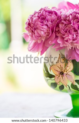 bouquet of pink peonies in a vase on the table