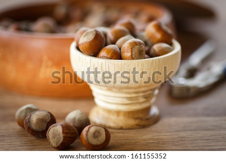 fresh hazelnuts in the shell on a wooden table