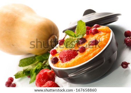 pumpkin porridge with berries on a white background