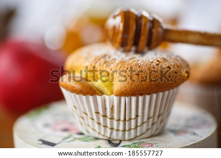 sweet honey muffins sprinkled with powdered sugar on a wooden table