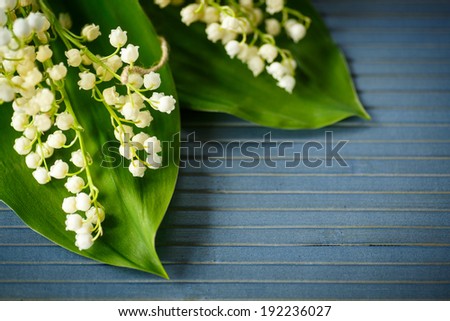 bouquet of lilies of the valley on a blue rustic table
