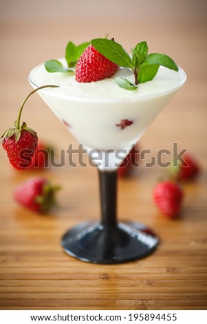 milk with strawberry jelly in glasses on a wooden table