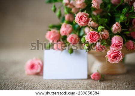beautiful bouquet of pink roses on an old table of burlap