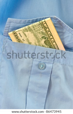 the money is in the pocket of a blue shirt
