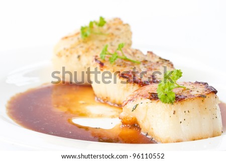 fried scallops with soy sauce on white plate
