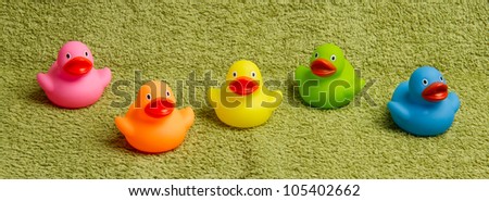 Rubber ducks isolated on a green towel
