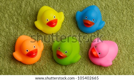 Rubber ducks isolated on a green towel