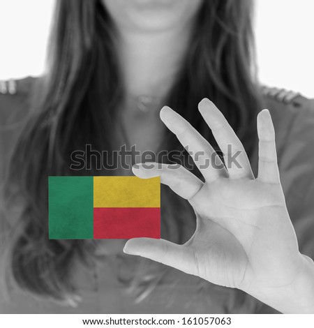 Woman showing a business card, black and white, Benin