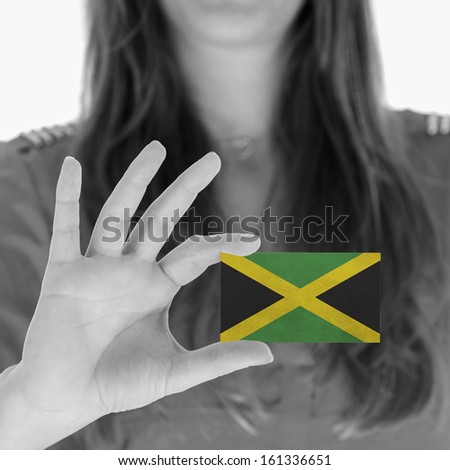 Woman showing a business card, black and white, Jamaica