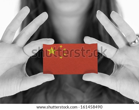 Woman showing a business card, black and white, China