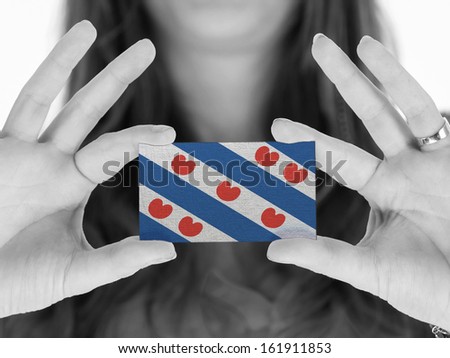 Woman showing a business card, black and white, Friesland