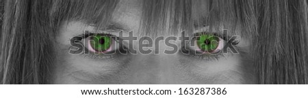 Close-up of the eyes, young woman, black and white, evil green eyes
