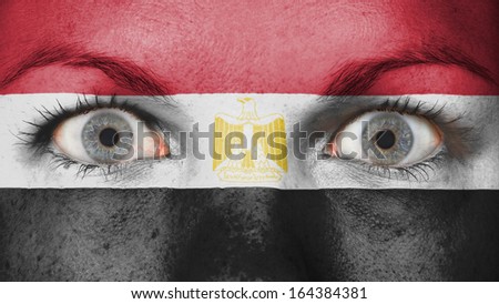 Close up of eyes. Painted face with flag of Egypt
