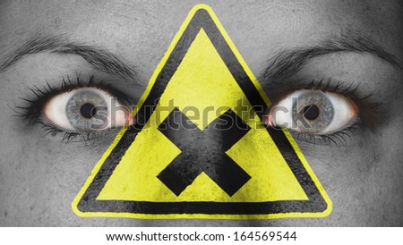 Close up of eyes. Painted face, danger, cross