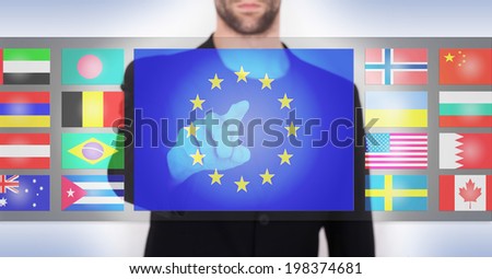 Hand pushing on a touch screen interface, choosing language or country, European Union