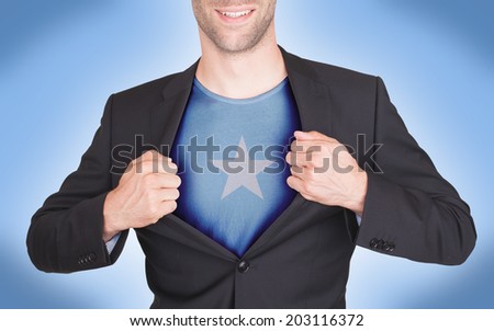 Businessman opening suit to reveal shirt with flag, Somalia