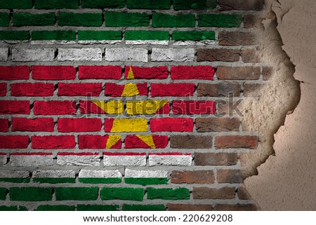 Dark brick wall texture with plaster - flag painted on wall - Suriname