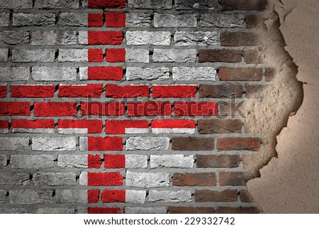 Dark brick wall texture with plaster - flag painted on wall - England
