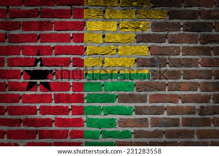 Very old dark red brick wall texture with flag - Guinea Bissau