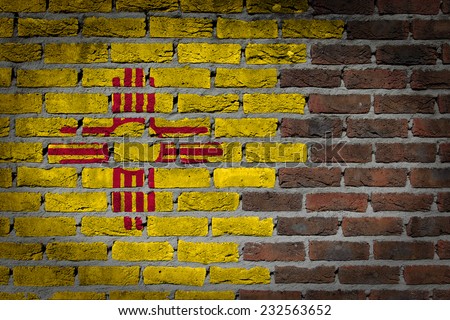 Very old dark red brick wall texture with flag - New Mexico