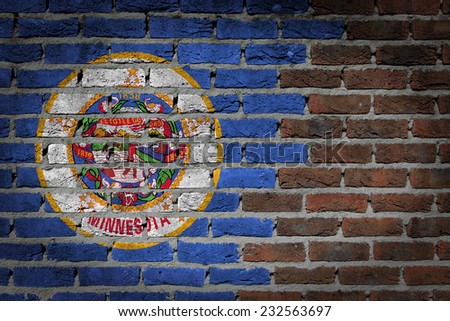 Very old dark red brick wall texture with flag - Minnesota